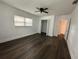 Bright bedroom with ceiling fan, window and wood-look flooring at 7631 43Rd St N, Pinellas Park, FL 33781