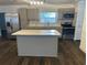 Well-lit kitchen with light gray cabinets, island, and stainless steel appliances at 7631 43Rd St N, Pinellas Park, FL 33781
