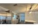 Modern kitchen with stainless steel refrigerator, island, and light gray cabinets at 7631 43Rd St N, Pinellas Park, FL 33781