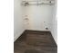Cozy laundry area with sleek, dark wood-look flooring and a convenient overhead shelf at 7631 43Rd St N, Pinellas Park, FL 33781