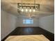 Large living area with modern chandelier and hard flooring at 7631 43Rd St N, Pinellas Park, FL 33781