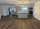Bright living room with hardwood flooring, island and stainless steel appliances at 7631 43Rd St N, Pinellas Park, FL 33781
