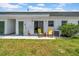 Relaxing backyard with patio area, chairs, and sliding glass doors for easy indoor/outdoor living at 7850 40Th N Ave # 7850, St Petersburg, FL 33709
