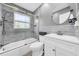 Stylish bathroom with tiled shower and tub, white vanity, and modern fixtures at 7850 40Th N Ave # 7850, St Petersburg, FL 33709