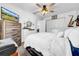 Bright bedroom with ceiling fan, dresser, and television at 7850 40Th N Ave # 7850, St Petersburg, FL 33709