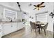 Bright eat-in kitchen features tile backsplash, ceiling fan, and an abundance of natural light at 7850 40Th N Ave # 7850, St Petersburg, FL 33709