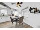 Eat-in kitchen features modern dining set, white cabinets and backsplash at 7850 40Th N Ave # 7850, St Petersburg, FL 33709