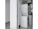 Clean laundry area with stacked washer and dryer and white walls at 7850 40Th N Ave # 7850, St Petersburg, FL 33709