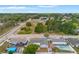 An aerial view shows homes with fenced yards, and neighborhood streets in a beautiful residential area at 8010 Chickasaw Ln, Port Richey, FL 34668