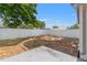 Backyard featuring a rock garden, fresh mulch, landscaped border, and grass, ideal for outdoor activities at 8010 Chickasaw Ln, Port Richey, FL 34668