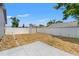 Backyard featuring a shed, framed by a white fence, and grass, ideal for outdoor activities or relaxing at 8010 Chickasaw Ln, Port Richey, FL 34668