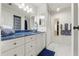 Bathroom with a blue-topped white vanity and a large mirror at 8010 Chickasaw Ln, Port Richey, FL 34668