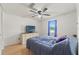 Bedroom with wood-look floors, ceiling fan, dresser and a queen-size bed at 8010 Chickasaw Ln, Port Richey, FL 34668