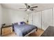 Bedroom with wood-look floors, ceiling fan, built-in closets and a queen-size bed at 8010 Chickasaw Ln, Port Richey, FL 34668