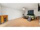 Bedroom with wood-look floors, fireplace, TV, ceiling fan and a queen-size bed at 8010 Chickasaw Ln, Port Richey, FL 34668