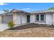 View of a single-story home featuring a well-maintained lawn, stone accents, and a covered entryway at 8010 Chickasaw Ln, Port Richey, FL 34668