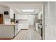 Bright kitchen featuring white cabinetry, stainless steel appliances, and a skylight for ample natural light at 8010 Chickasaw Ln, Port Richey, FL 34668