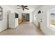 Sun room with tile floors, white walls, ceiling fan, sliding glass door, and pet door provides a versatile space at 8010 Chickasaw Ln, Port Richey, FL 34668