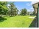Expansive backyard featuring lush green grass and mature shade trees at 8105 Valley Stream Ln, Hudson, FL 34667