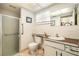 Bathroom featuring a glass-enclosed shower, tiled flooring, and a large mirror at 8105 Valley Stream Ln, Hudson, FL 34667