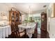 Formal dining room with chandelier lighting, hardwood floors, and a view to the outdoor scenery at 8105 Valley Stream Ln, Hudson, FL 34667