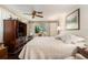 Bright main bedroom featuring a large window, and a television with wardrobe closet at 8105 Valley Stream Ln, Hudson, FL 34667