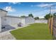 Spacious backyard featuring a well-maintained lawn, privacy fence, and a paved patio area at 812 60Th S St, Gulfport, FL 33707