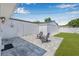 Backyard with patio area, lush lawn, and a white privacy fence perfect for outdoor living at 812 60Th S St, Gulfport, FL 33707
