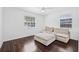 Bright bedroom with two windows, hardwood floors and a comfortable seating arrangement at 812 60Th S St, Gulfport, FL 33707