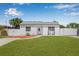 Charming home with a well-manicured lawn and inviting front porch with seating at 812 60Th S St, Gulfport, FL 33707
