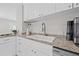 Bright kitchen features granite counters, stainless appliances, white cabinets, and open floorplan at 812 60Th S St, Gulfport, FL 33707