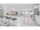 Modern kitchen featuring granite countertops, stainless steel appliances, breakfast bar, and open floor plan at 812 60Th S St, Gulfport, FL 33707