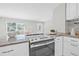 Bright kitchen features granite counters, stainless appliances, white cabinets, and breakfast bar at 812 60Th S St, Gulfport, FL 33707