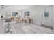 Bright and airy living room featuring a modern open concept and luxury vinyl plank flooring at 812 60Th S St, Gulfport, FL 33707