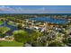 Neighborhood aerial view of house beside a golf course, pond, and upscale homes and mature trees at 852 Cordova Ne Blvd, St Petersburg, FL 33704