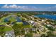 Aerial view of house and neighborhood beside golf course, lake, mature trees and many upscale homes at 852 Cordova Ne Blvd, St Petersburg, FL 33704