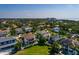 Aerial view of home in a neighborhood with mature trees, a manicured lawn, and other upscale homes at 852 Cordova Ne Blvd, St Petersburg, FL 33704