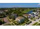 An aerial view of the neighborhood with lush landscaping, a golf course, and views of the waterway at 852 Cordova Ne Blvd, St Petersburg, FL 33704
