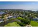 Aerial view of a home near a pond surrounded by mature trees and upscale homes in a neighborhood at 852 Cordova Ne Blvd, St Petersburg, FL 33704