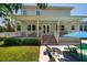 Charming backyard featuring a pool, patio, and beautifully manicured lawn, perfect for outdoor entertainment and relaxation at 852 Cordova Ne Blvd, St Petersburg, FL 33704