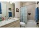 Well-lit bathroom with marble countertops, a bathtub with shower and modern vanity at 852 Cordova Ne Blvd, St Petersburg, FL 33704
