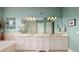 Bathroom with double vanity, large mirrors, and a shower at 852 Cordova Ne Blvd, St Petersburg, FL 33704