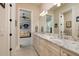 Bright bathroom featuring a double vanity with granite countertops and an open doorway to the sitting area at 852 Cordova Ne Blvd, St Petersburg, FL 33704