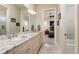 Bright bathroom featuring a double vanity with granite countertops and an open doorway to a bedroom at 852 Cordova Ne Blvd, St Petersburg, FL 33704