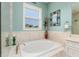 Soaking tub in bathroom with a decorative vase at 852 Cordova Ne Blvd, St Petersburg, FL 33704