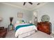 Relaxing bedroom with blue accents, a plush bed, a wooden dresser, and an attached bathroom at 852 Cordova Ne Blvd, St Petersburg, FL 33704