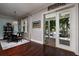 Bright dining room with hardwood floors, views of the outside patio, and a dark table at 852 Cordova Ne Blvd, St Petersburg, FL 33704