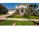 Inviting two-story home has an attached two-car garage, walkway and a beautiful garden at 852 Cordova Ne Blvd, St Petersburg, FL 33704
