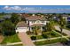 Charming home exterior featuring a brick driveway, a two-car garage, and manicured landscaping at 852 Cordova Ne Blvd, St Petersburg, FL 33704