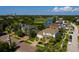 Charming curb appeal with lush landscaping, palm trees, and serene golf course views at 852 Cordova Ne Blvd, St Petersburg, FL 33704